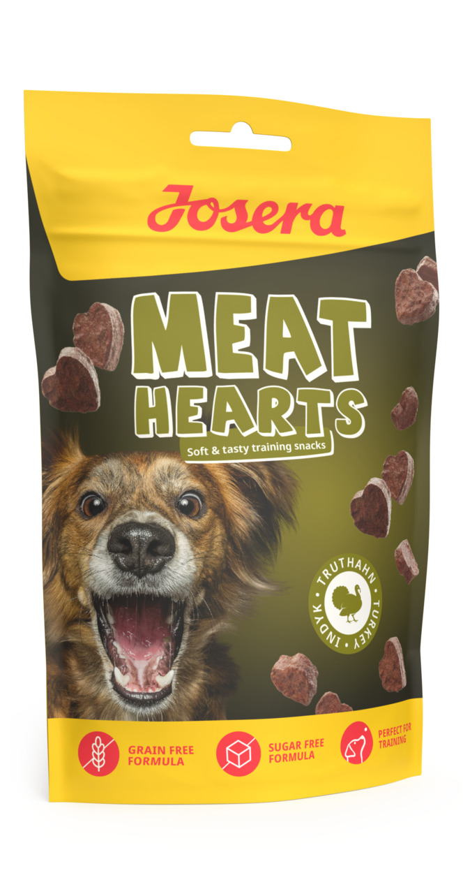 Das Bild zeigt eine gelb-schwarze Verpackung der Marke Josera mit der Aufschrift „Meat Hearts“. Es handelt sich um weiche und schmackhafte Trainingssnacks für Hunde mit Truthahngeschmack. Die Verpackung enthält Symbole für „Getreidefreie Formel“, „Zuckerf