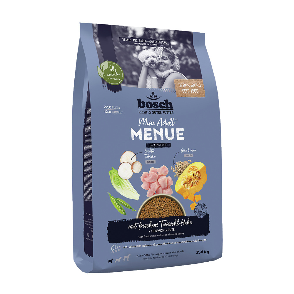 Das Bild zeigt eine Verpackung des Hundefutters „bosch Mini Adult Menue“ der Marke bosch Tiernahrung. Es handelt sich um ein getreidefreies Trockenfutter für ausgewachsene Hunde kleiner Rassen. Die Geschmacksrichtung ist frisches Tierwohl-Huhn mit feinen 