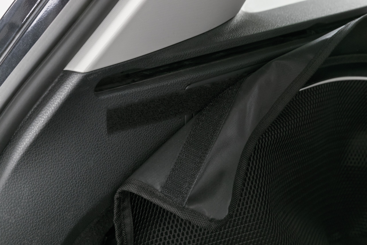 Das Bild zeigt das TRIXIE Schutzgitter für den Kofferraum eines Autos, speziell entwickelt für Hunde. Es besteht aus robustem, schwarzem Netzmaterial und wird mit Klettverschlüssen sicher befestigt. Das Produkt richtet sich an Hundebesitzer, die ihre Tier