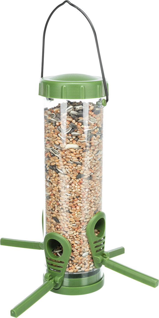 Das Bild zeigt einen transparenten Vogelfutterspender der Marke TRIXIE, gefüllt mit einer Mischung aus verschiedenen Samen und Körnern. Der Spender ist zylindrisch, hat einen grünen Deckel, drei Sitzstangen und Futteröffnungen, die für Wildvögel geeignet 