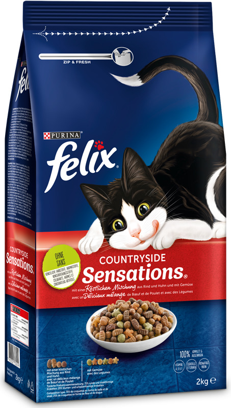 Das Bild zeigt eine Verpackung des Katzenfutters „Felix Countryside Sensations“ von Purina. Es handelt sich um eine 2-kg-Packung mit einer knusprigen Mischung aus Rind, Huhn und Gemüse. Die Zielgruppe sind Katzen. Die Verpackung betont Frische durch einen
