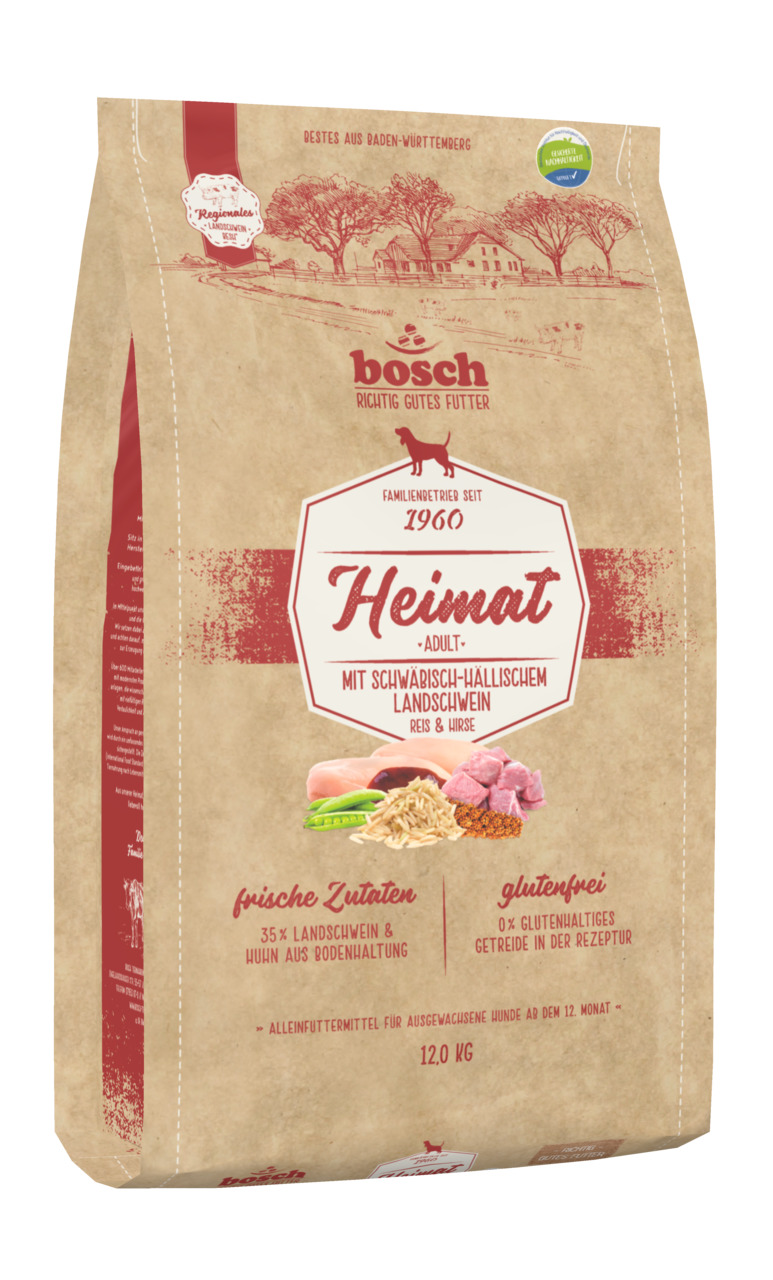 Das Bild zeigt eine 12-kg-Packung Hundefutter der Marke bosch Tiernahrung, Produktname "Heimat Adult". Es ist geeignet für ausgewachsene Hunde ab dem 12. Monat. Die Geschmacksrichtung ist Schwäbisch-Hällisches Landschwein mit Reis und Hirse. Das Futter is