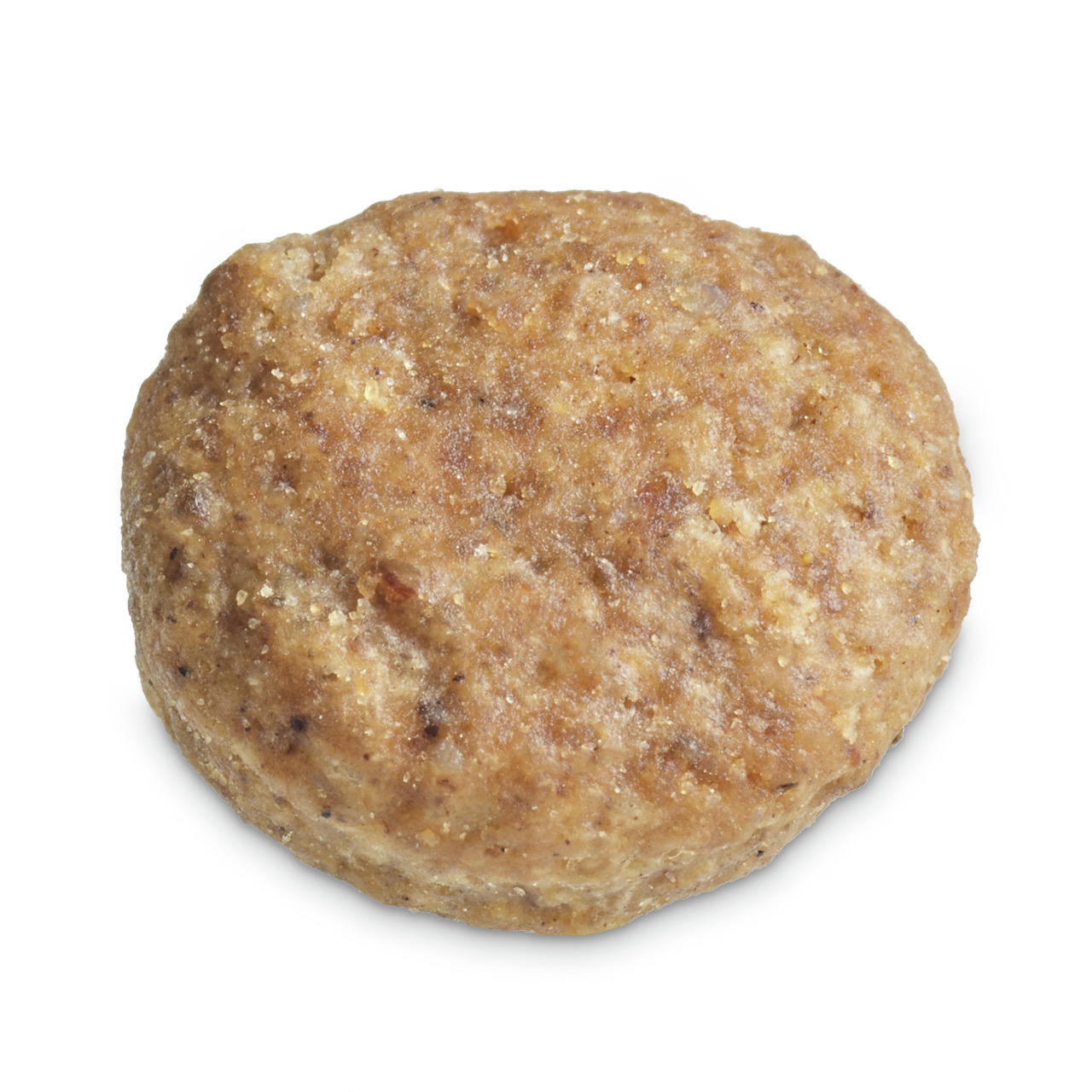 Das Bild zeigt ein einzelnes, rundes Hundeleckerli der Marke TIKAANI. Es handelt sich um ein Produkt für Hunde, das als Snack oder Belohnung dient. Die Oberfläche ist leicht unregelmäßig und zeigt eine bräunliche Farbe, die auf natürliche Zutaten hinweist