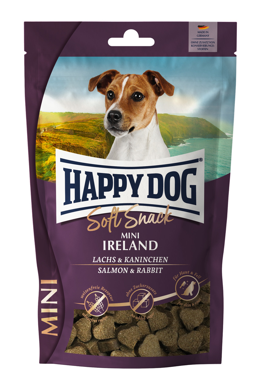 Die Abbildung zeigt eine violette Verpackung des Produkts „Happy Dog Soft Snack Mini Ireland“. Es handelt sich um getreidefreie Hundesnacks mit Lachs und Kaninchen, geeignet für kleine Hunde. Die Verpackung enthält 100 g und wirbt mit Vorteilen für Haut u
