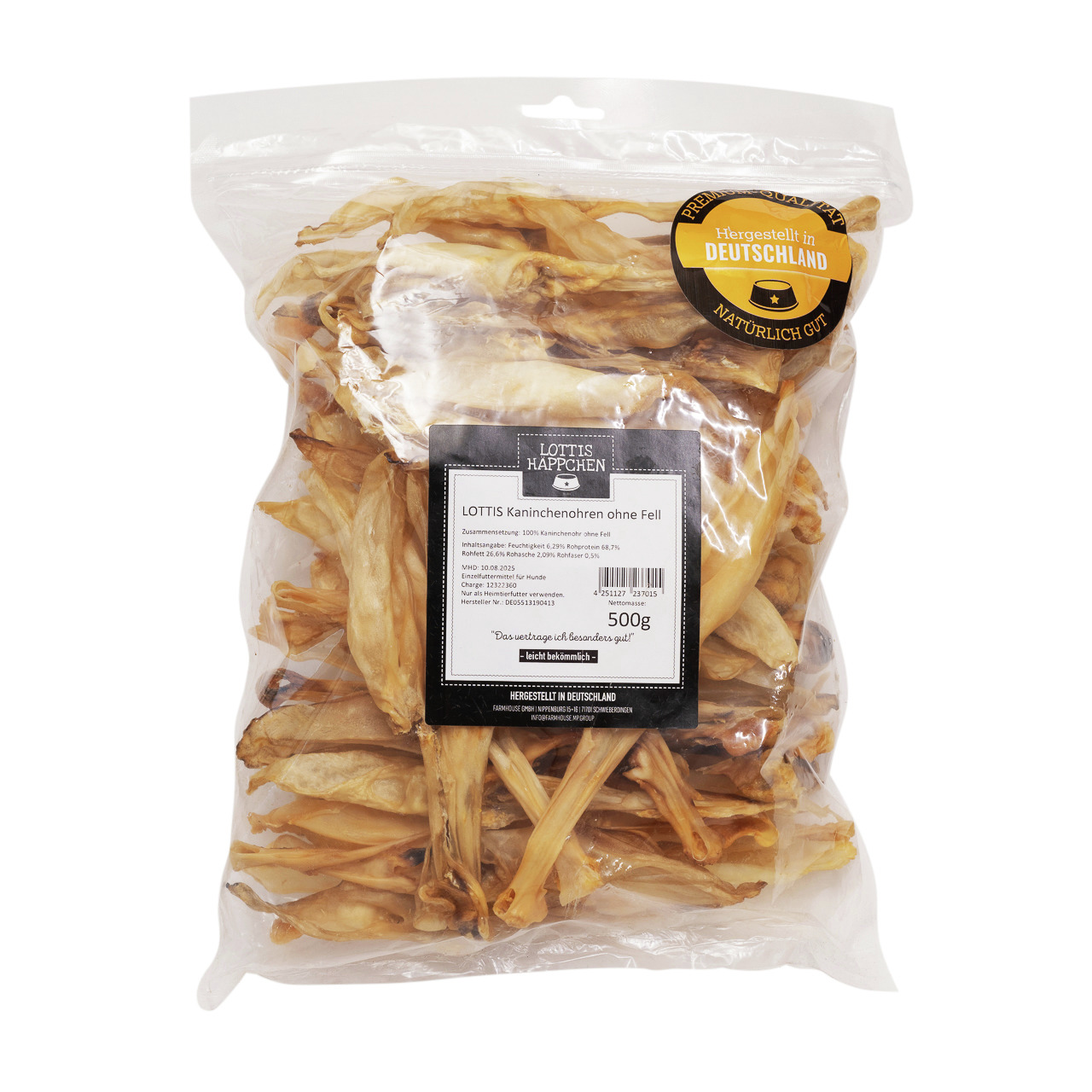 Das Bild zeigt eine transparente Verpackung mit 500 g "LOTTIS HÄPPCHEN Kaninchenohren ohne Fell", einem natürlichen Kausnack für Hunde. Die Marke wirbt mit der Aussage "Hergestellt in Deutschland" und "Natürlich gut". Der Inhalt besteht aus getrockneten K