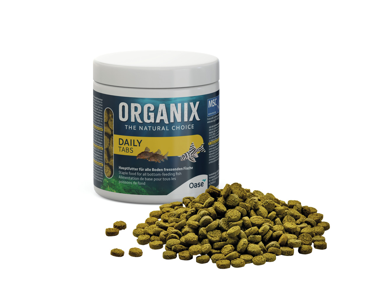 Das Bild zeigt eine Dose des Fischfutters „Organix Daily Tabs“ der Marke Oase, speziell für bodenfressende Fische. Die Verpackung ist weiß mit einem blauen Etikett, auf dem Produktinformationen und ein Fischmotiv abgebildet sind. Vor der Dose liegt eine M
