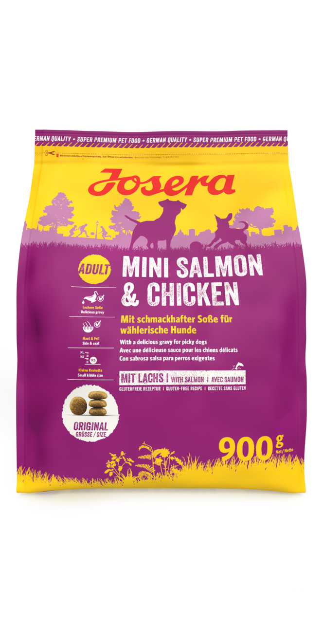 Das Bild zeigt eine 900 g Packung Josera Mini Salmon & Chicken Trockenfutter für ausgewachsene Hunde. Die Verpackung ist in Gelb und Lila gestaltet und zeigt Silhouetten von Hunden in einer Wiese. Das glutenfreie Futter enthält Lachs und Huhn, ist speziel