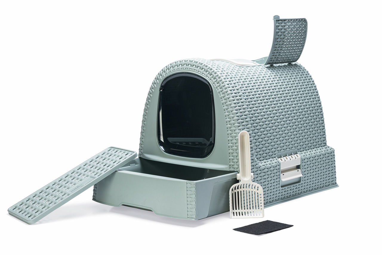 Das Bild zeigt die Curver Katzentoilette im Rattan-Design, geeignet für Katzen. Sie ist in einem hellgrauen Farbton gehalten und verfügt über eine Schublade zur einfachen Reinigung, eine Streuschaufel und einen Aktivkohlefilter zur Geruchsbindung. Die Kat
