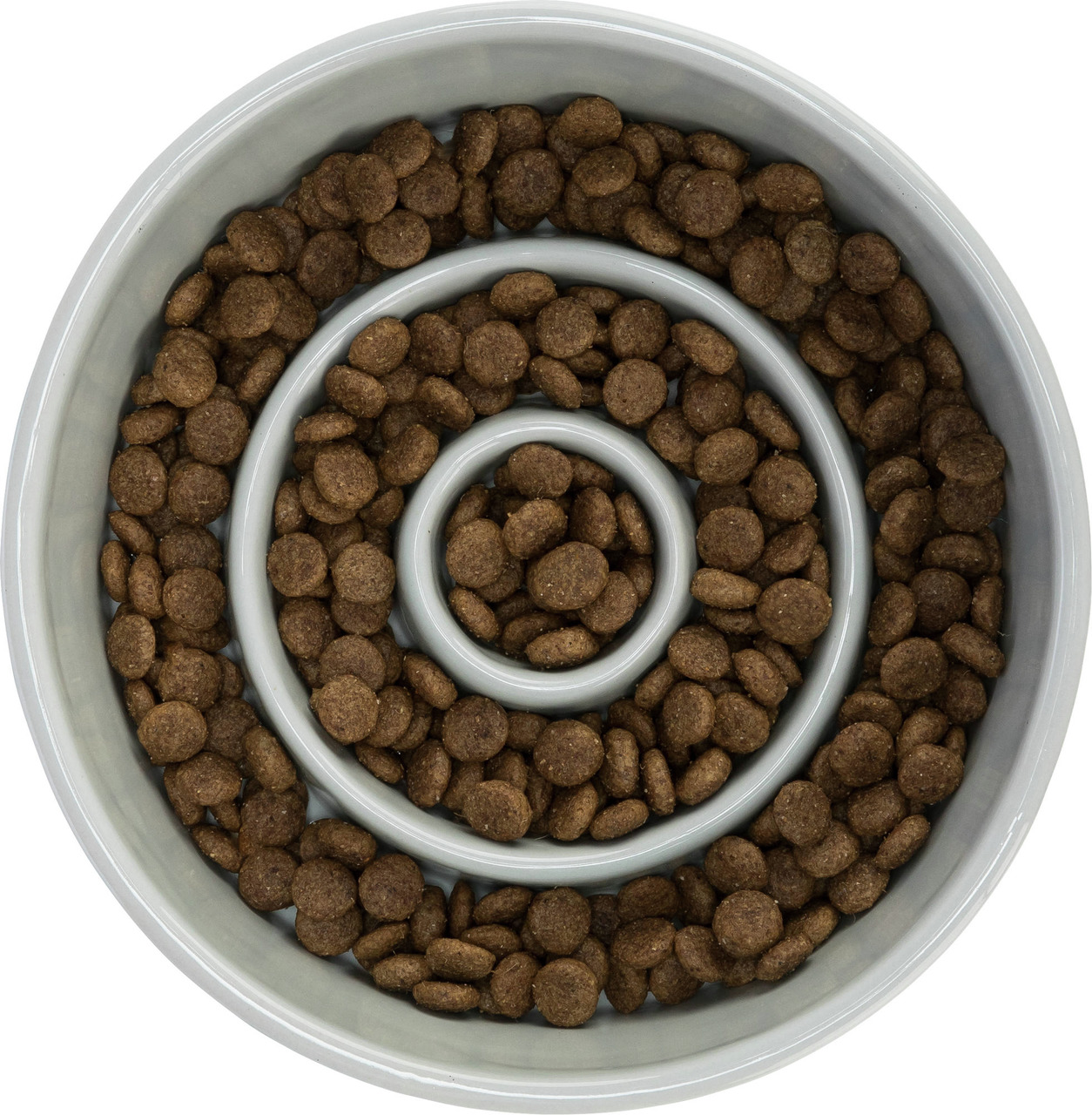 Das Bild zeigt den TRIXIE Napf „Slow Feed“, der speziell für Hunde entwickelt wurde, um das Fressen zu verlangsamen und die Verdauung zu fördern. Der Napf ist spiralförmig gestaltet und mit braunen Trockenfutterstücken gefüllt. Er eignet sich für Hunde al