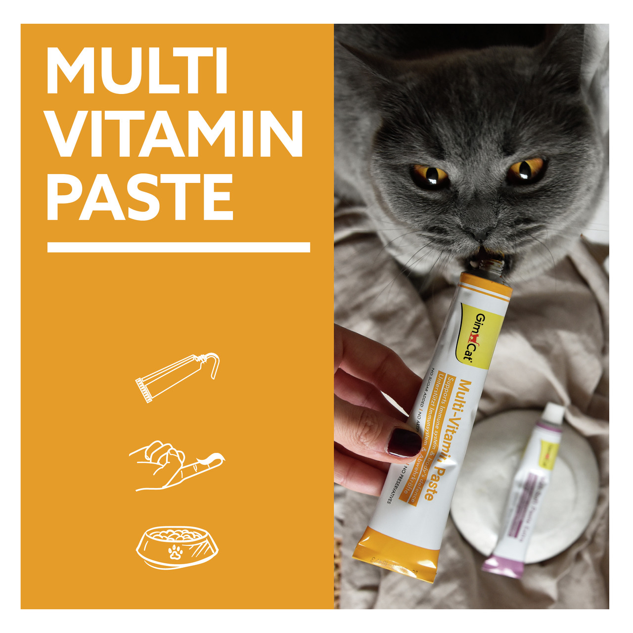 GimCat Multi-Vitamin Paste für Katzen, mit Vitaminen zur Immunstärkung, gelbe/weiße Tube, Katze schleckt direkt aus der Tube.