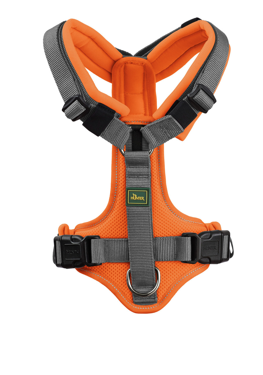 Das Bild zeigt ein hochwertiges Hundegeschirr der Marke HUNTER, Modell "Divo", in leuchtendem Orange mit grauen Akzenten. Es ist ergonomisch geformt, gepolstert und verfügt über verstellbare Gurte für optimalen Tragekomfort. Zielgruppe sind Hundehalter, d