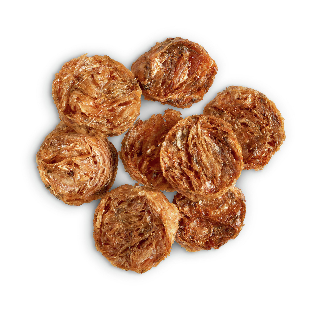 Auf dem Bild sind die natürlichen Hundesnacks „Lottis Häppchen“ zu sehen, die aus getrocknetem Fisch bestehen. Die Snacks sind speziell für Hunde geeignet und bieten eine proteinreiche, gesunde Belohnung. Sie sind in runden, goldbraunen Scheiben geformt u