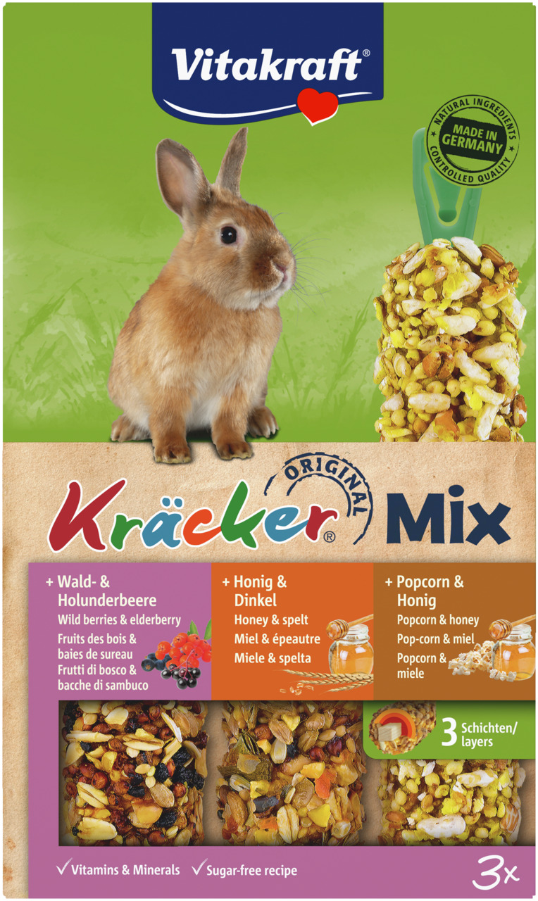 Das Bild zeigt das Produkt „Vitakraft Kräcker Mix“ für Kaninchen. Es enthält drei Geschmacksrichtungen: Wald- & Holunderbeere, Honig & Dinkel sowie Popcorn & Honig. Die Packung betont natürliche Zutaten, eine zuckerfreie Rezeptur und Vitamine. Enthalten s